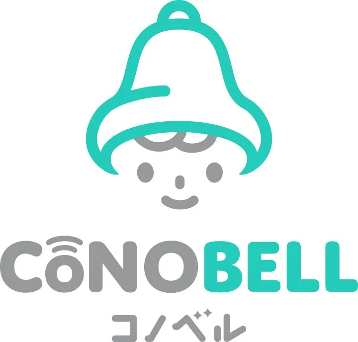 ベルの形をしたアイコンの中に笑顔の顔が描かれた可愛らしいロゴマークです。下部には「CoNOBELL」と「コノベル」の文字が配置されており、親しみやすい印象を与えます。