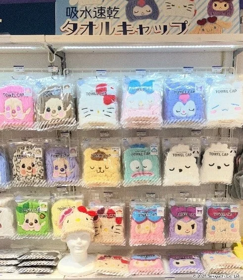 キャラクターデザインの吸水速乾タオルキャップが多数陳列されている棚の様子です。ハローキティやマイメロディなど、様々な人気キャラクターの商品が見られます。