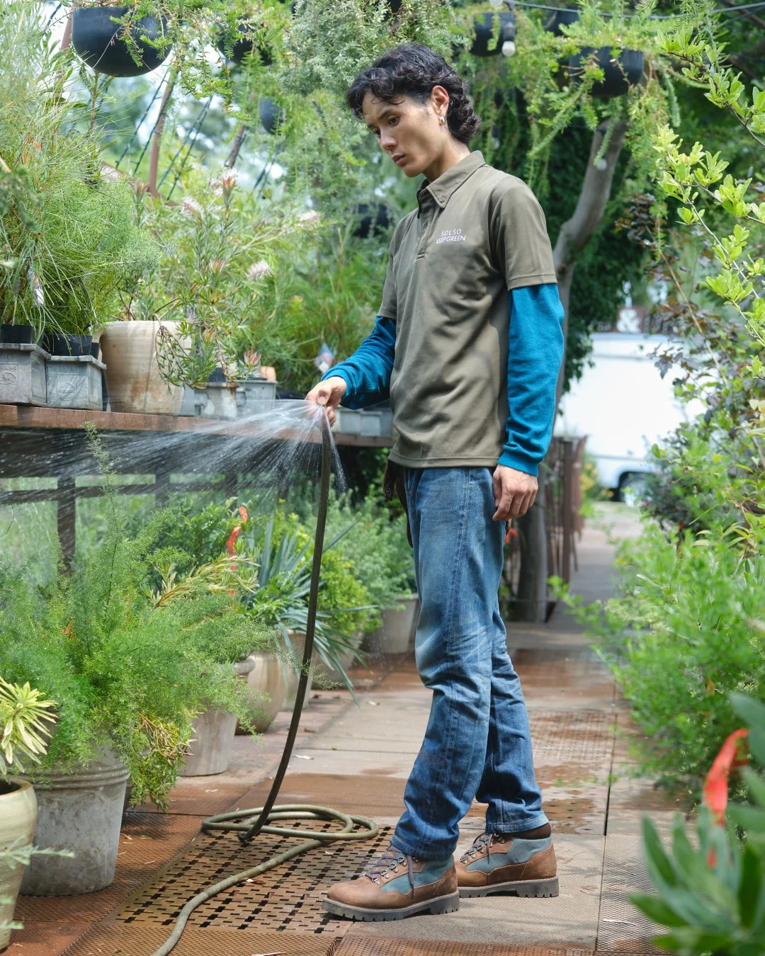 庭師が植物に水やりをする様子